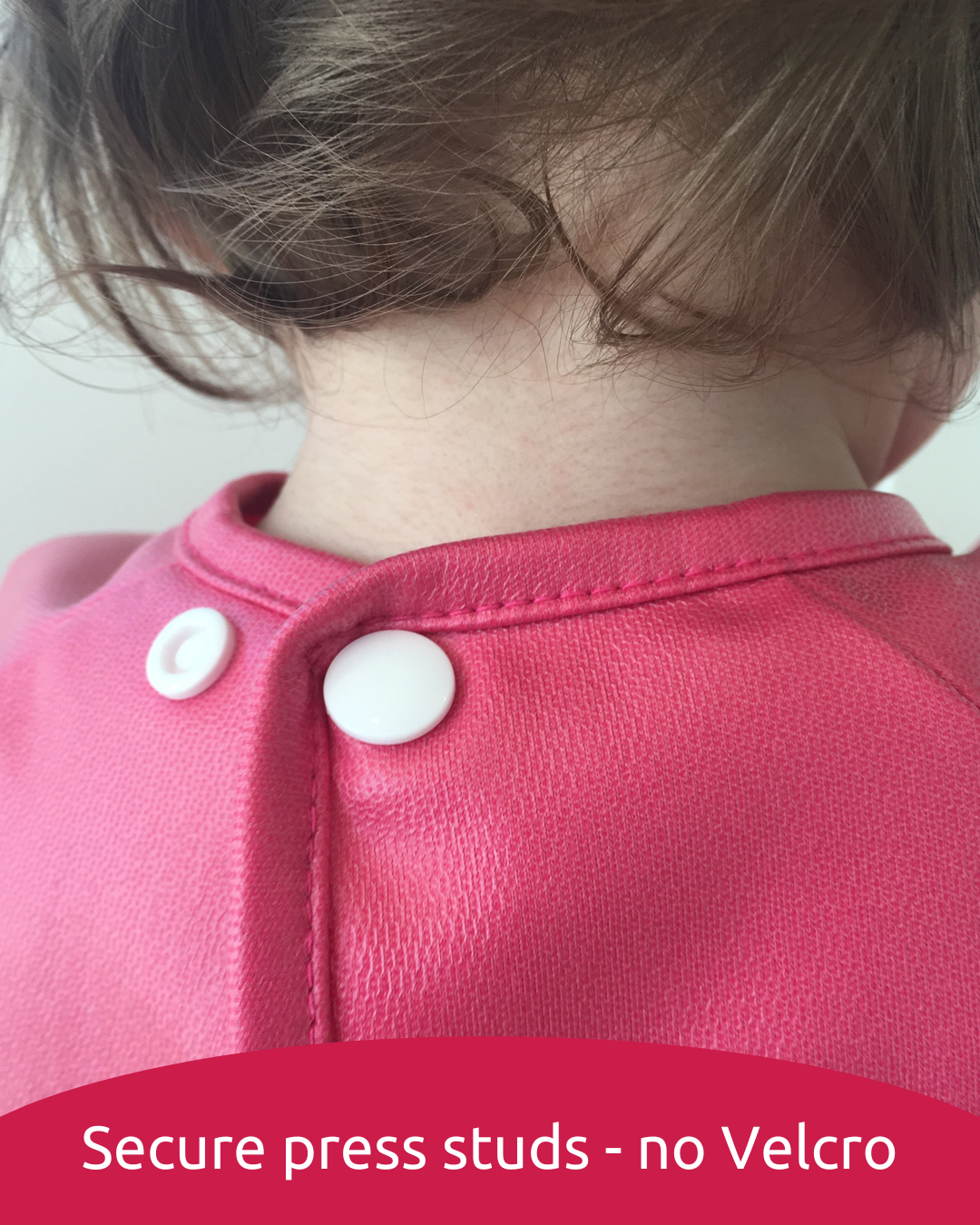 Press studs fastened at baby's neck.