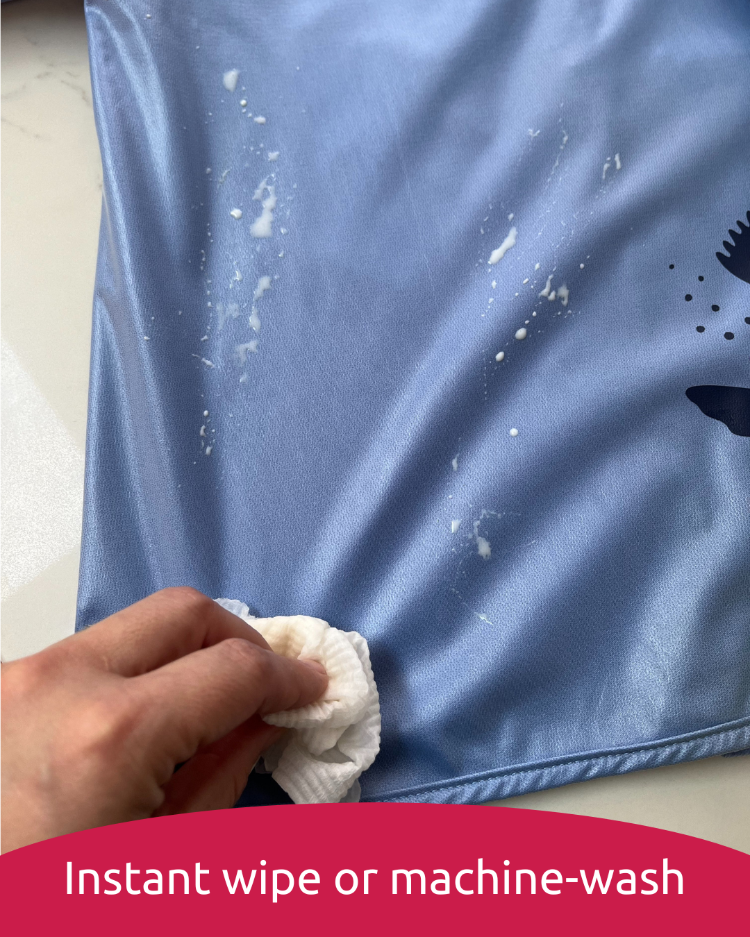 Waterproof baby smock being wiped clean.