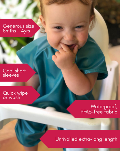 Girl wearing smock bib eating with features list