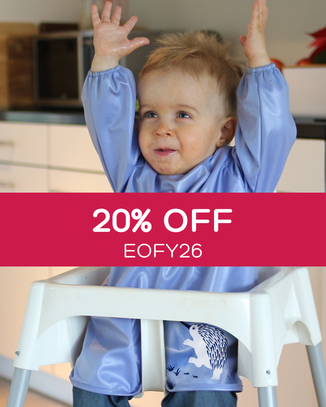 Toddler wearing a blue smock bib.