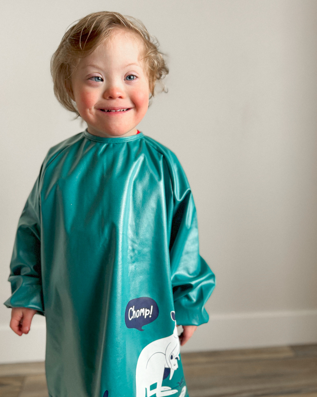 Boy wearing green disability bib.