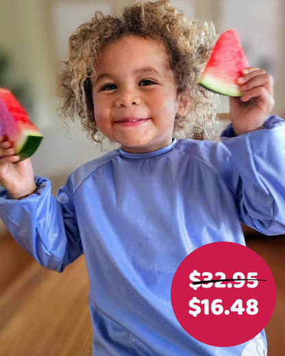 Child smock with boy eating watermelon.