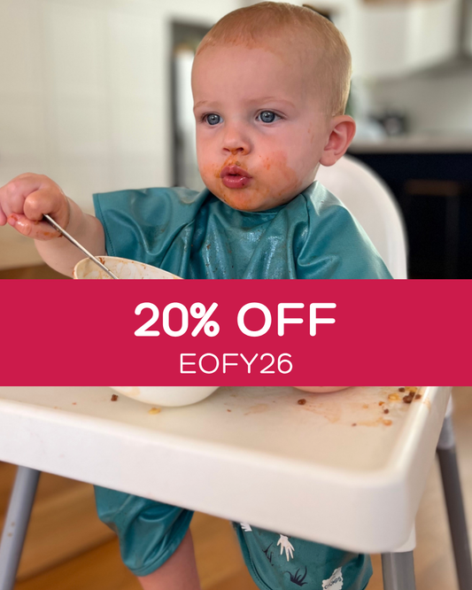 Boy wearing a short sleeve bib smock in green.