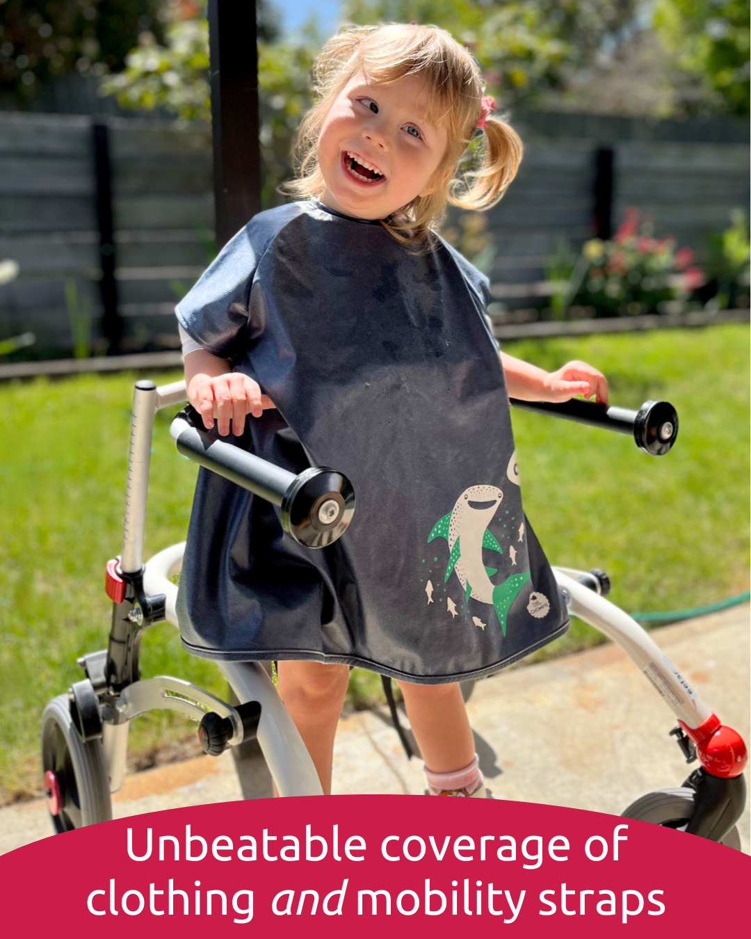 Girl wearing disability bib in mobility aid.