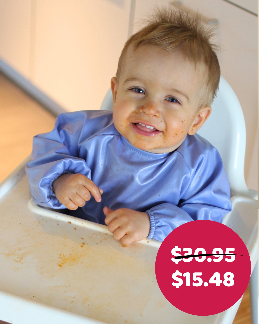 Boy in highchair in Blue Smock Bib.

